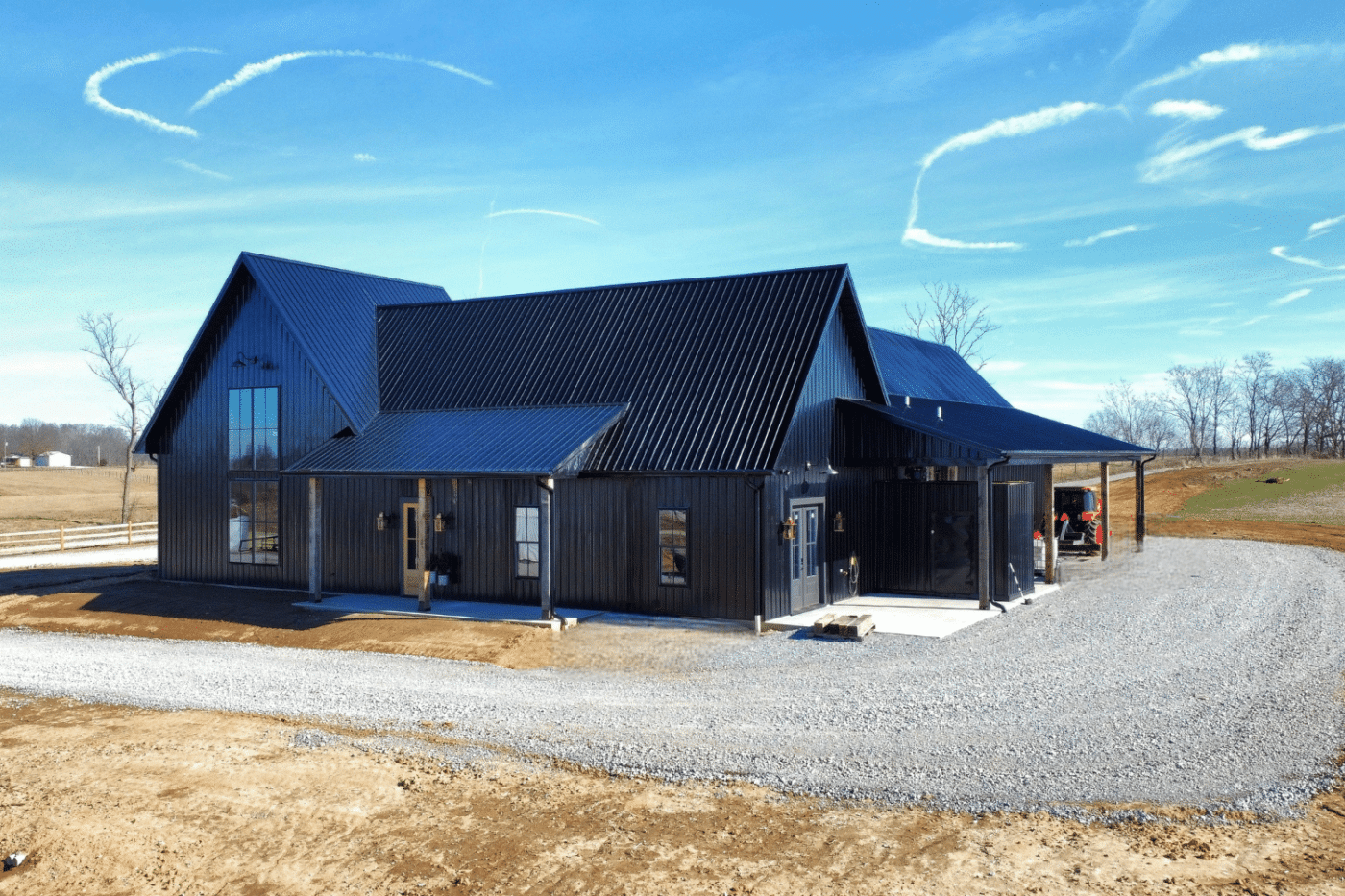 black 30x100 barndominium with tall windows and porches