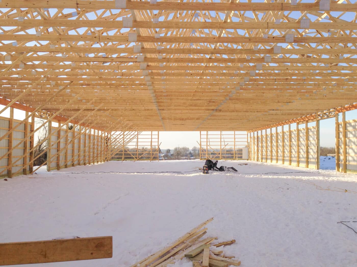 Picture from underneath a 30x40 equestrian pole barn that is under construction