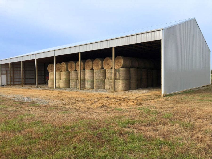 A 30x70 agricultural pole barn storing hay