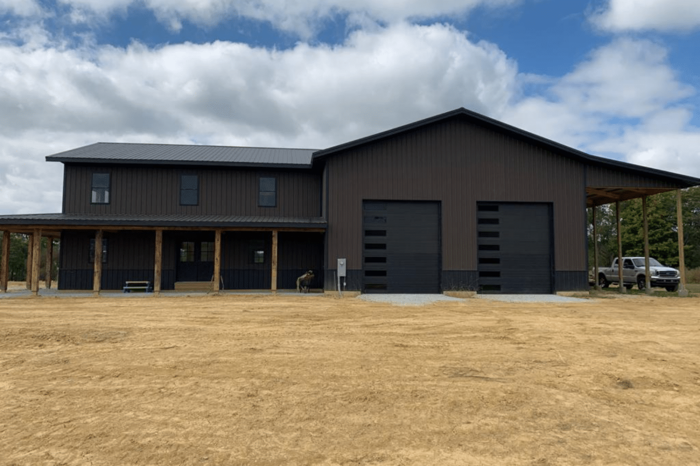 brown 50x60 garage pole barn kit with two black garages