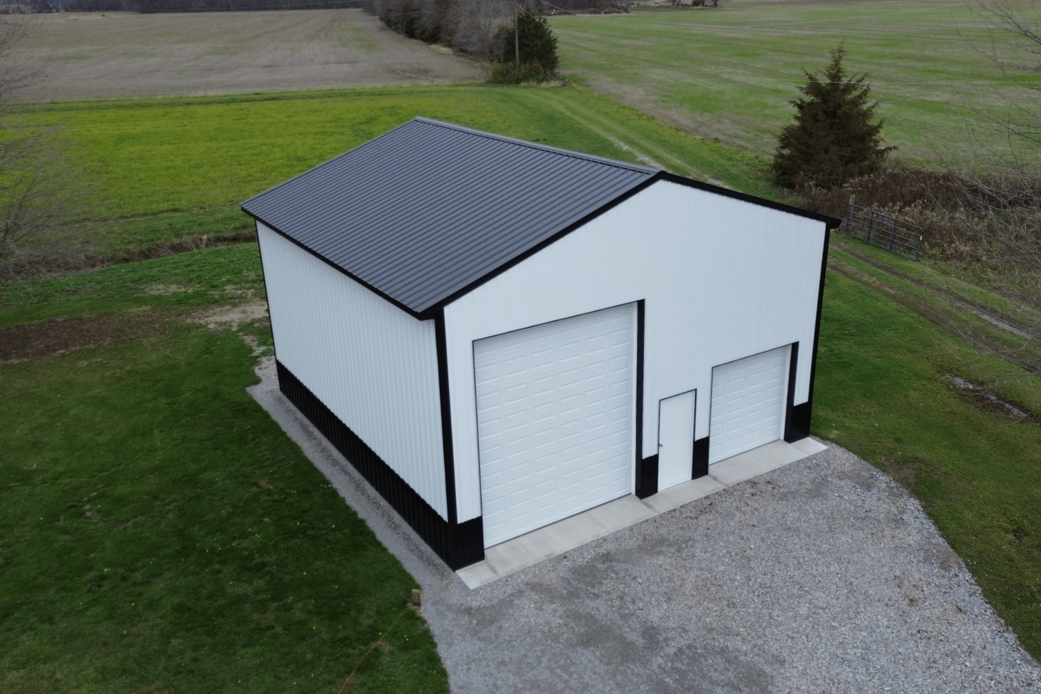 white 60x70 garage pole barn kit with black metal roof