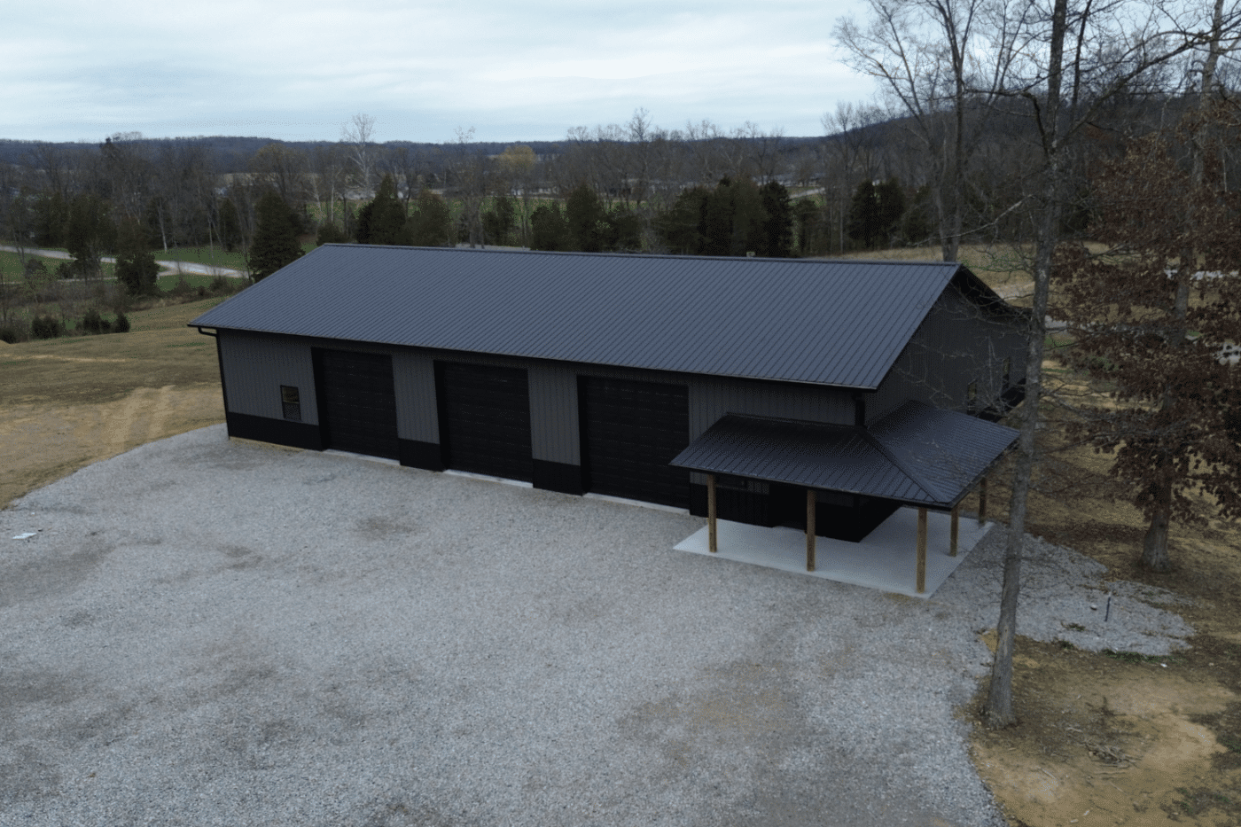 an 80x90 black and grey pole barn garage