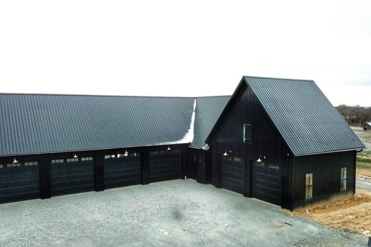 all black barndominium with attched pole barn garage