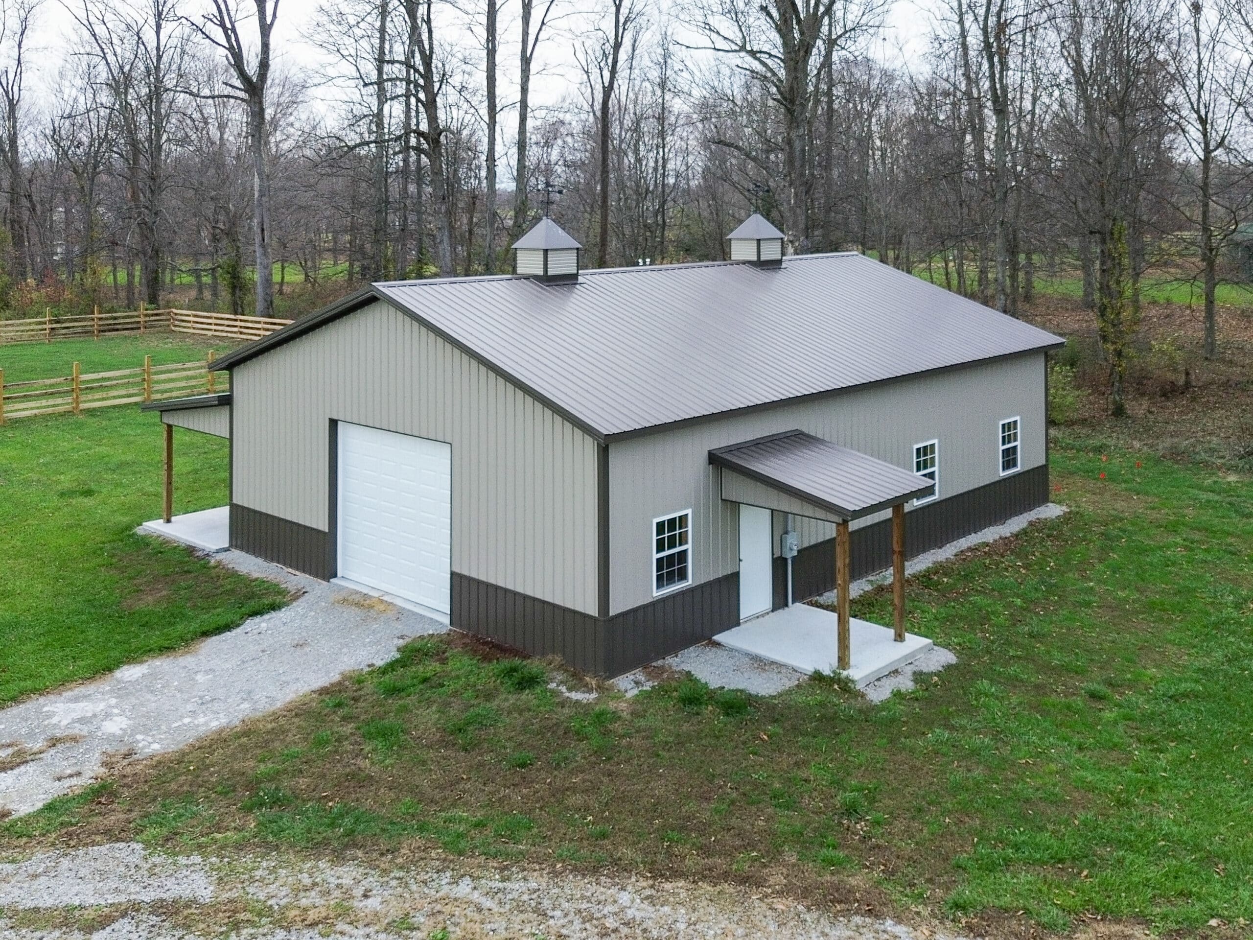 beige and brown 80x90 garage pole barn kit with one white garage and lean to porch