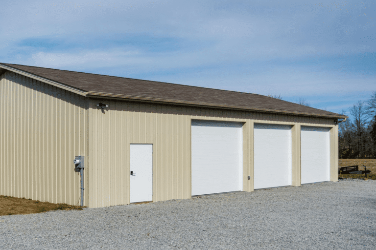 beige 40x80 garage pole barn kit with brown roof with 3 garages and an entry door