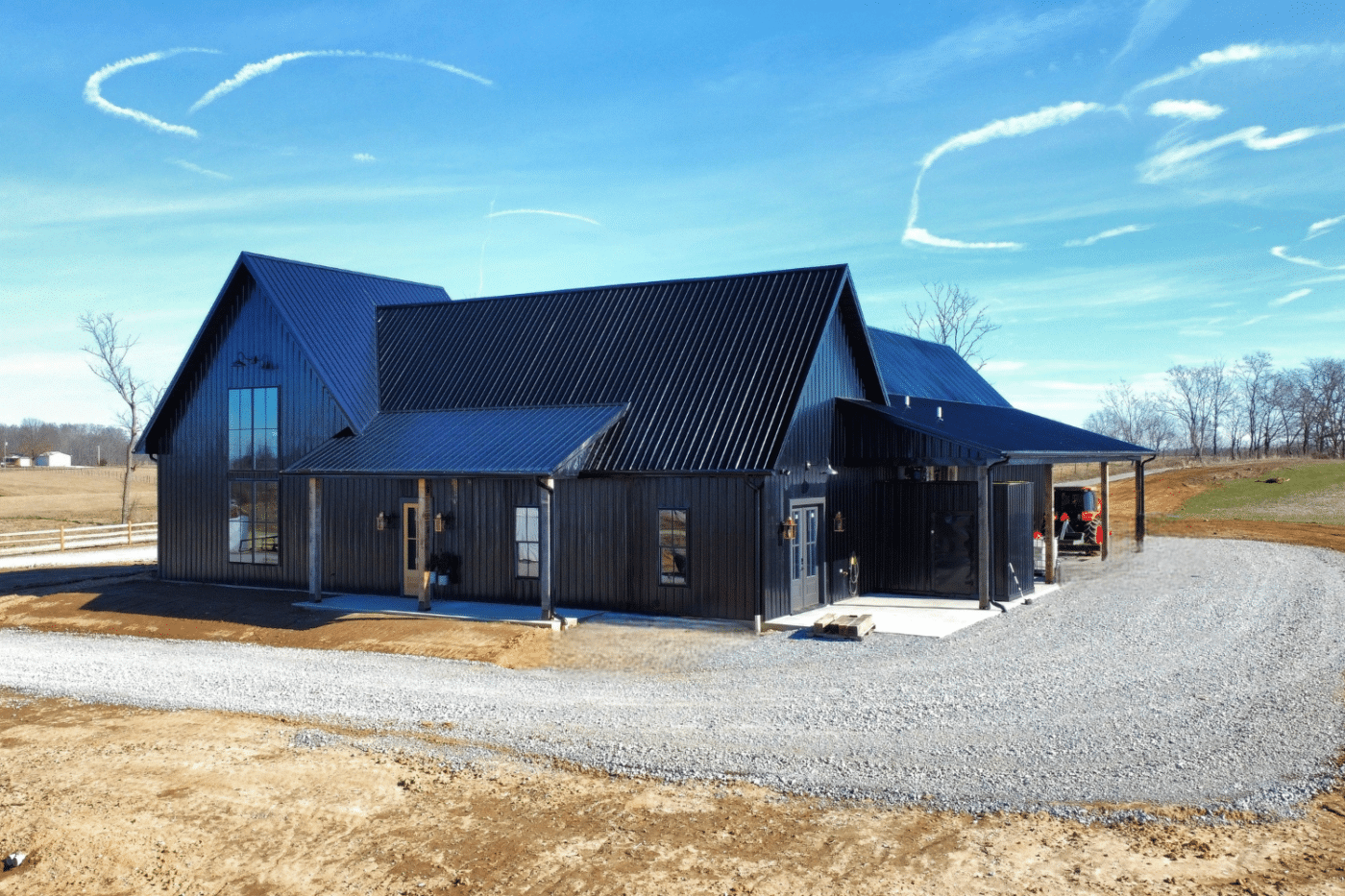 black 50x50 barndominium with tall windows and porch
