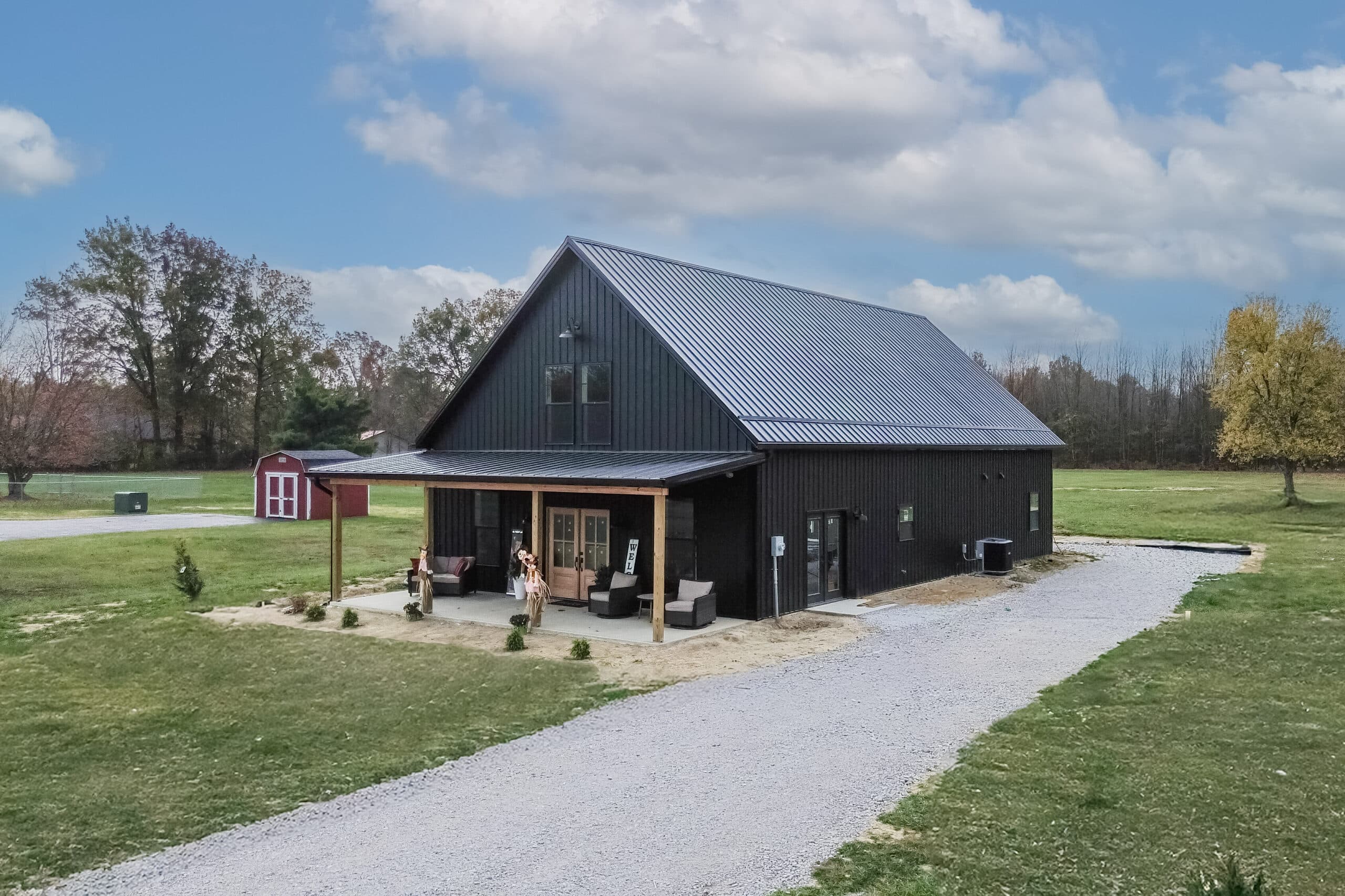 black barndominium kit with front overhang
