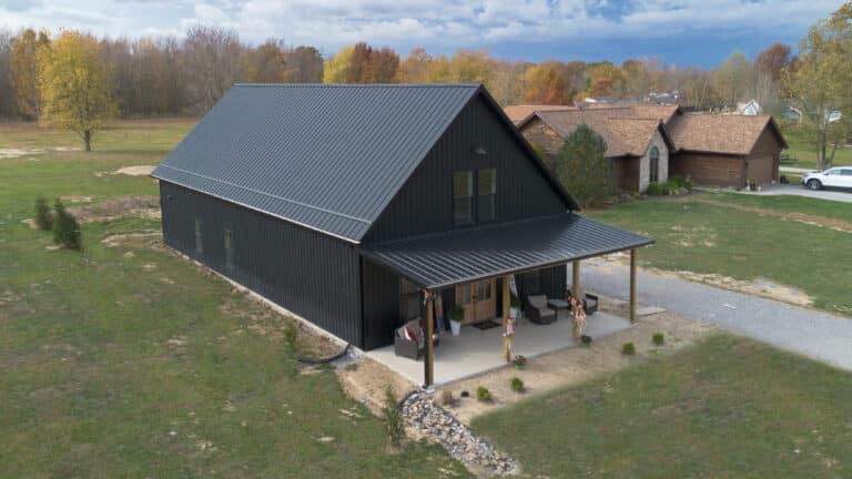 black barndominium with overhang from the left side