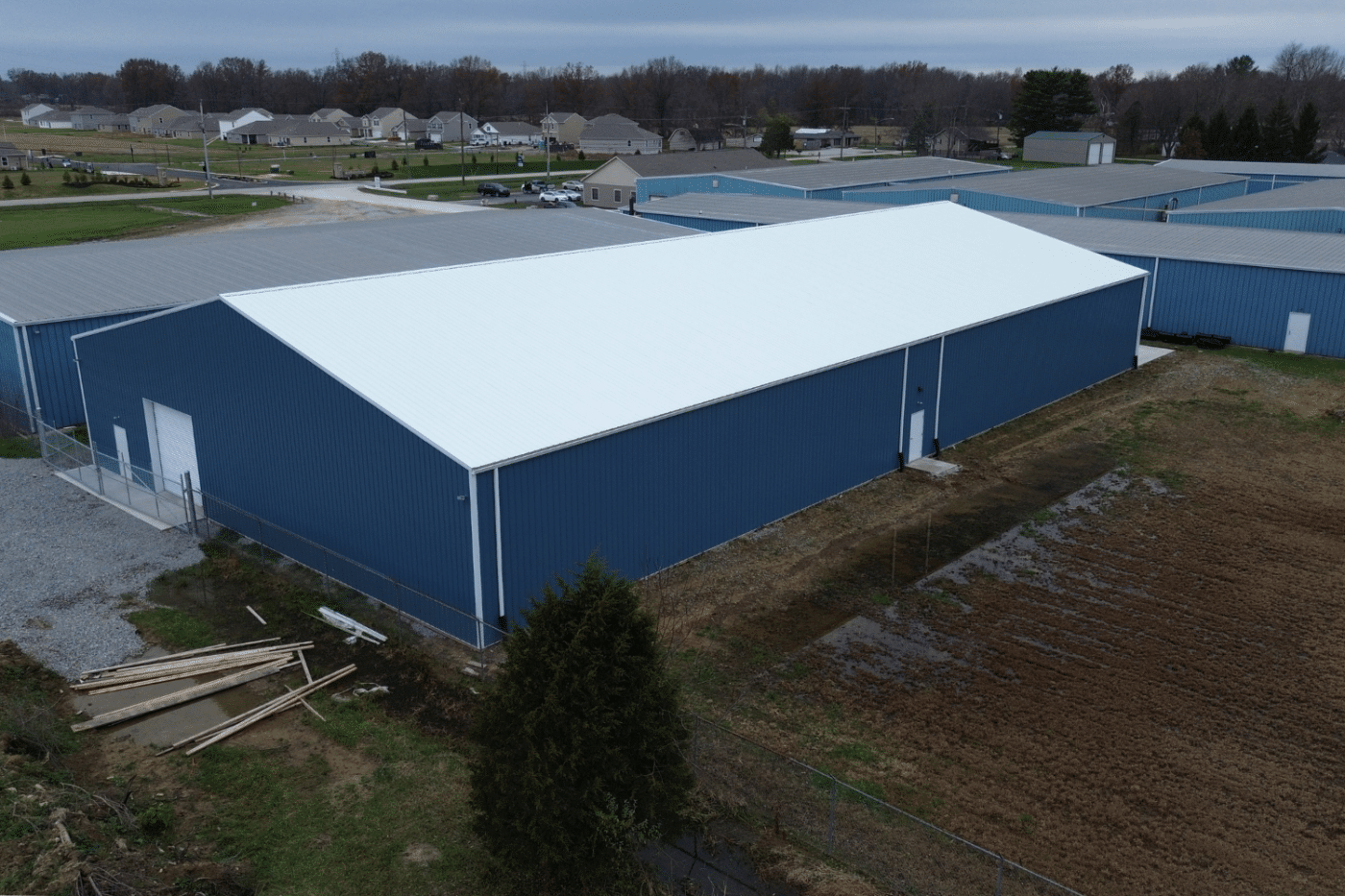 blue 60x100 agricultural pole barn kit with white metal roof