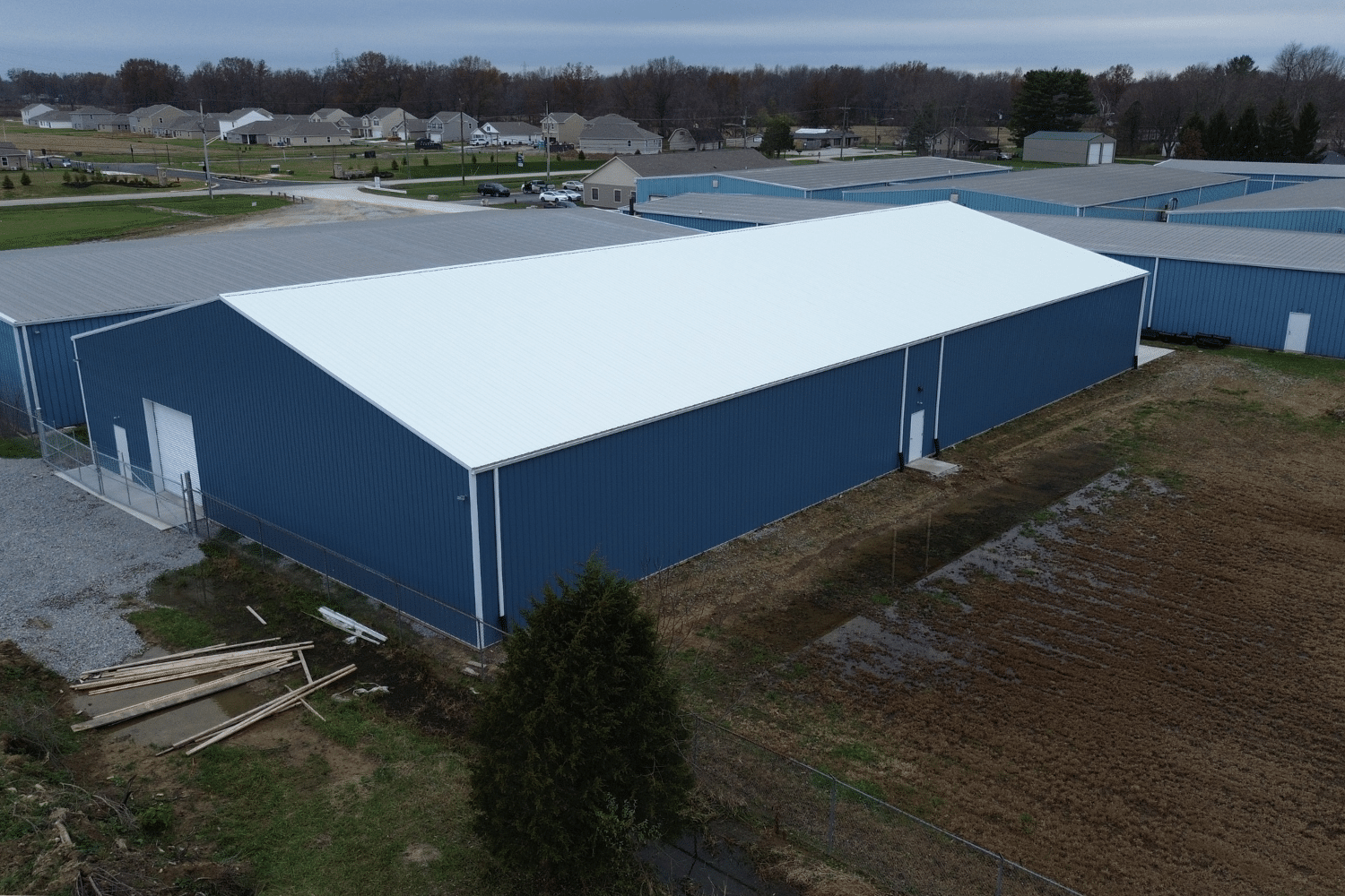 blue 60x100 agricultural pole barn kit with white metal roof