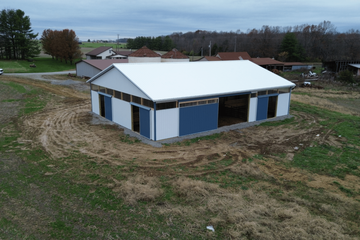 blue and white 60x100 agricultural pole barn kit with doors