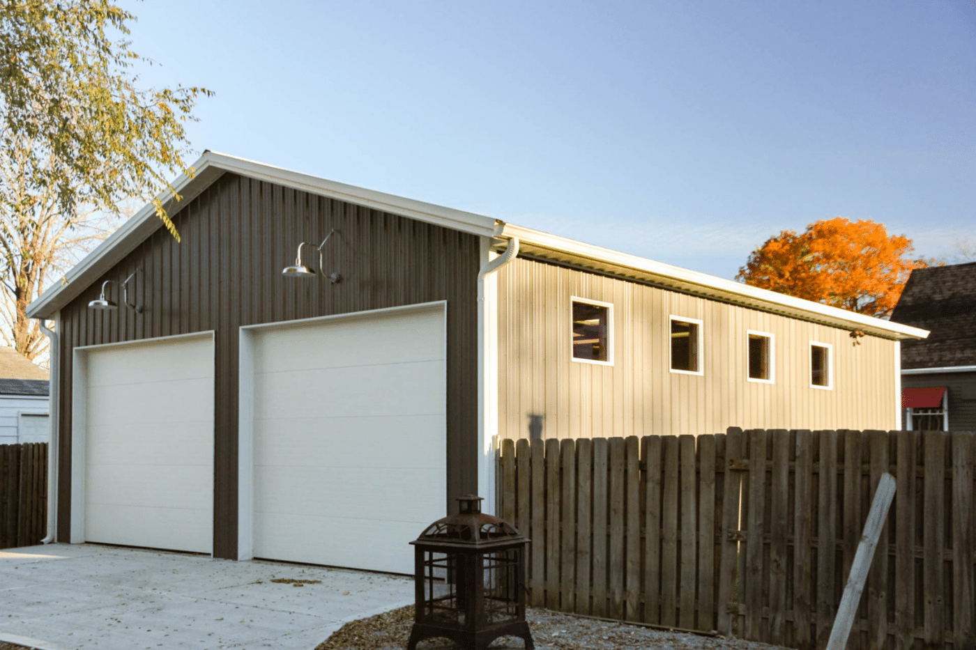 brown 40x100 garage pole barn kit with two white garages