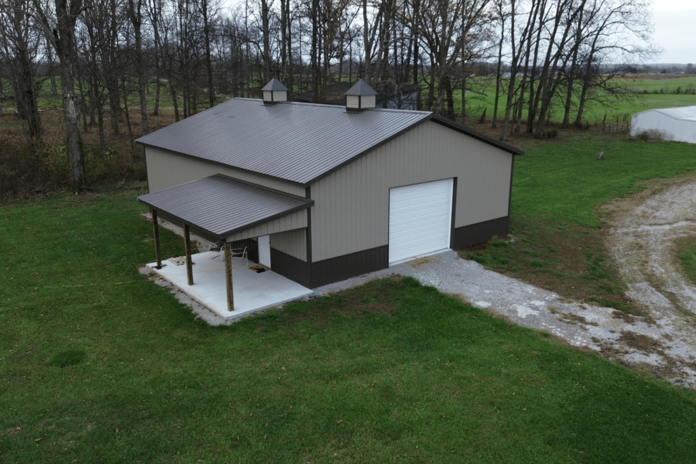 brown and cream 50x70 garage pole barn kit with lean to porch and white garage