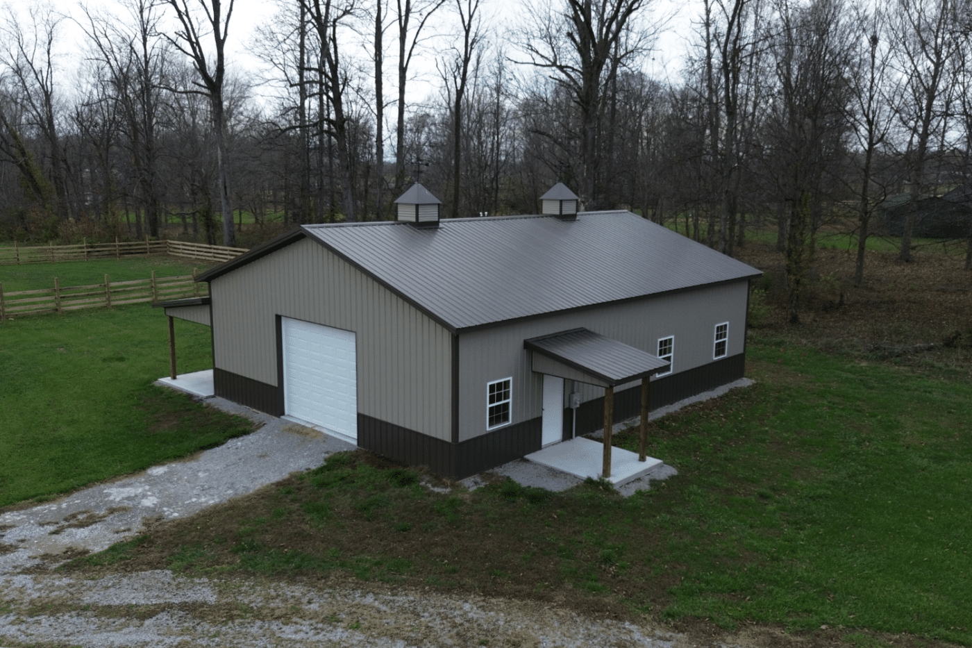 beige 80x120 garage pole barn with white garage and brown roof with cupolas