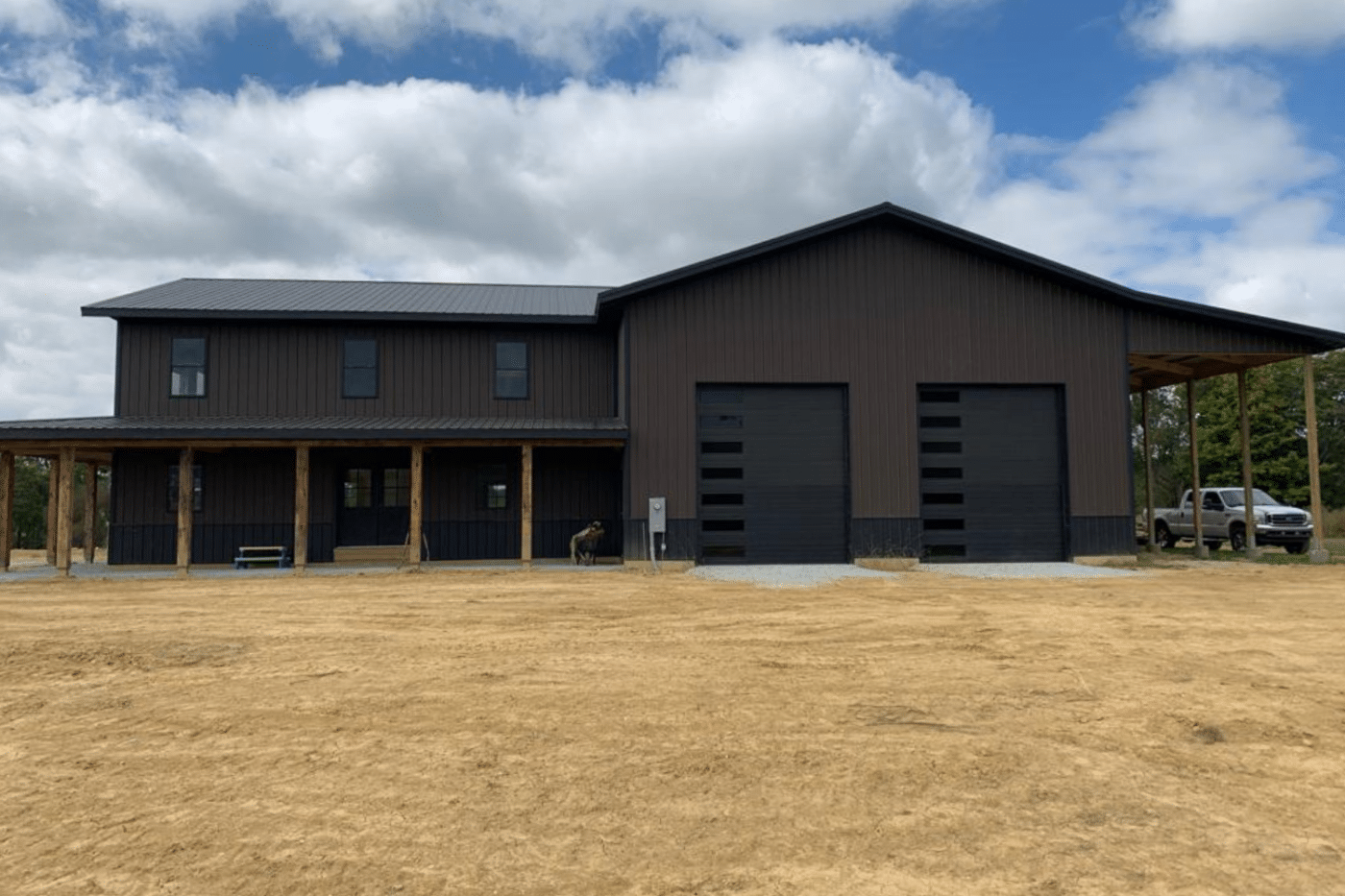brown 50x70 garage pole barn kit with two black garages