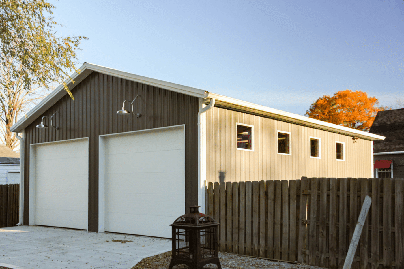 brown two car garage pole barn kit near fence in miamisburg oh