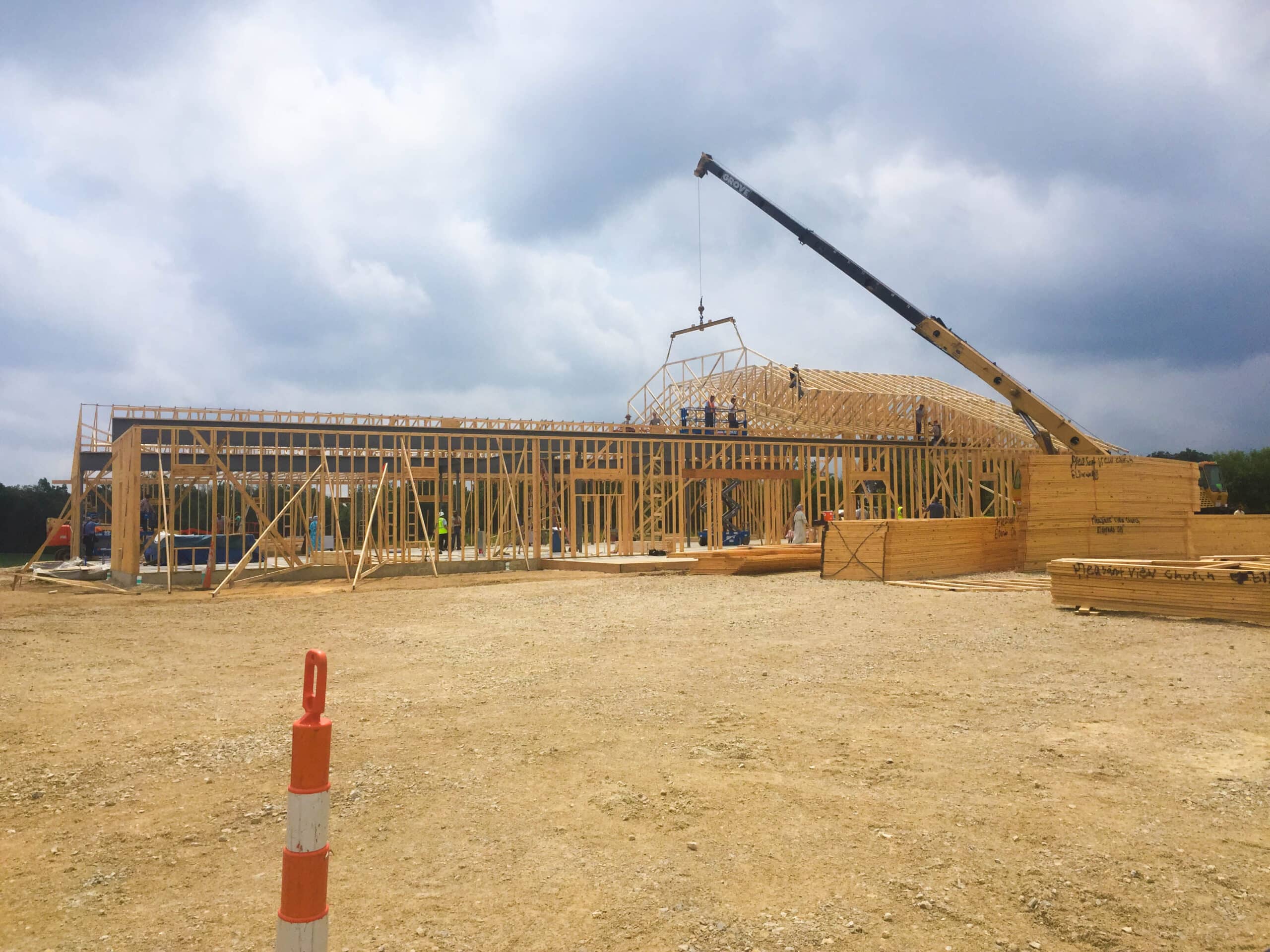 Crane lowering truss onto a roof in New Vienna OH