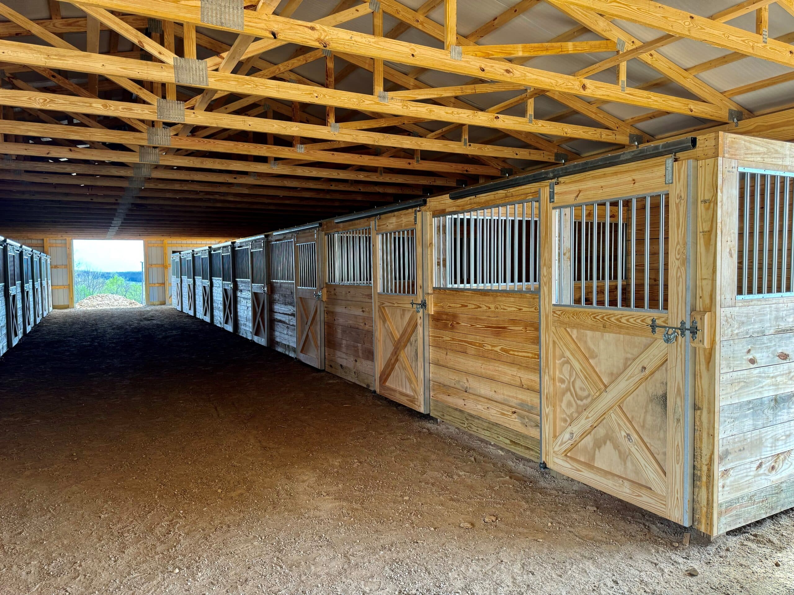 multiple wooden stalls inside 20x30 agricultural pole barn