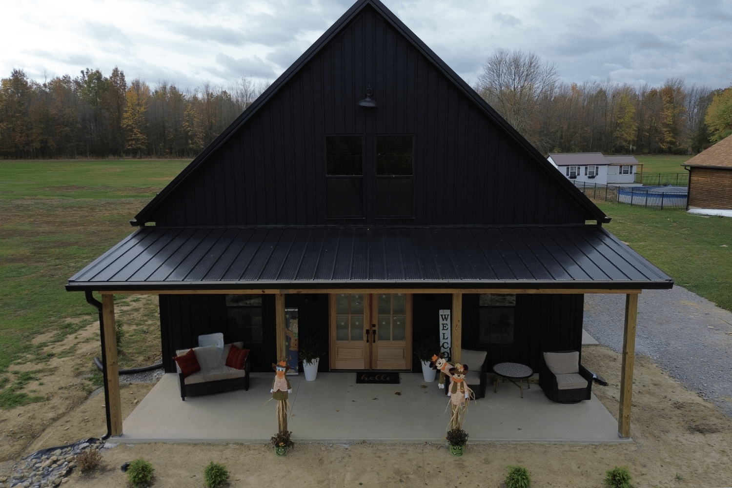 front of black 50x50 barndominum with porch