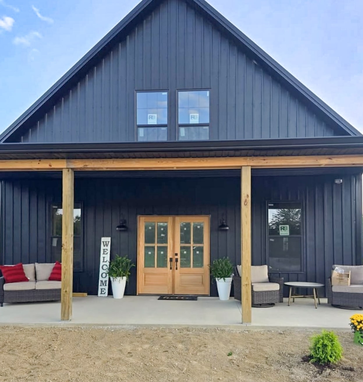 front of a black barndominium's front porch