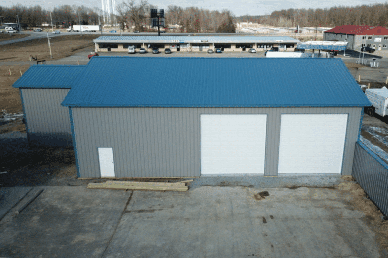 gray 80x120 garage pole barn kit with two white garages and blue roof