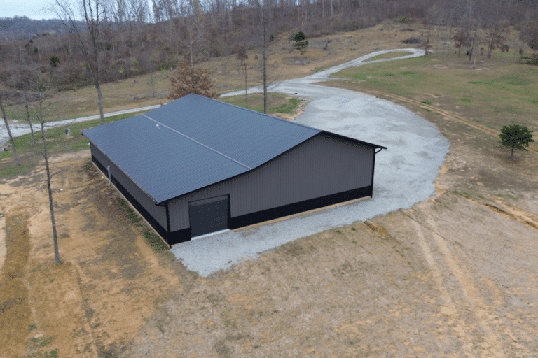 gray and black trimmed 40x80 pole barn garage with black metal roof and black overhead garage