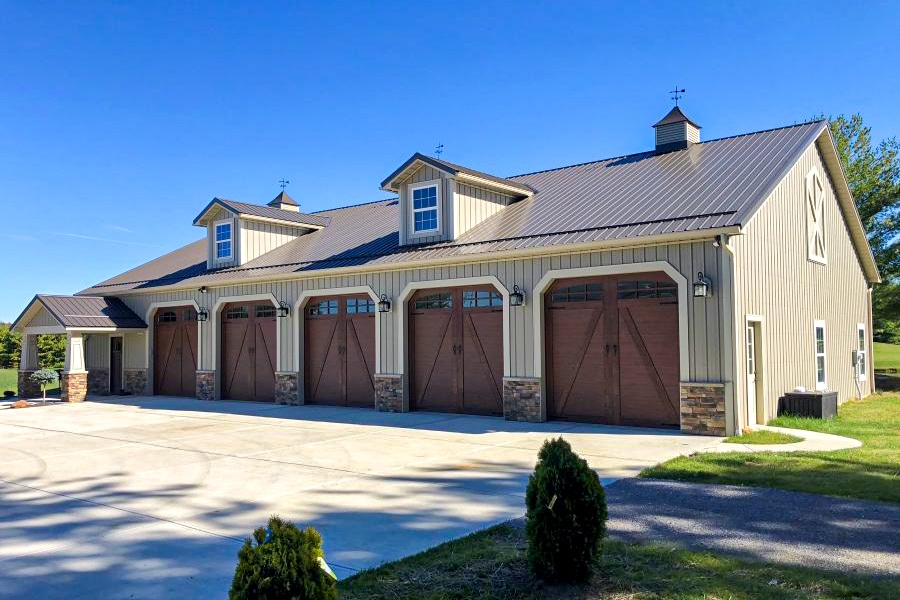 tan metal pole barn garage with white trim and white overhead garage door
