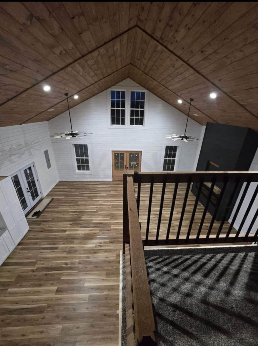 interior of a barndominium with multiple rooms and floors and wood flooring and ceilings