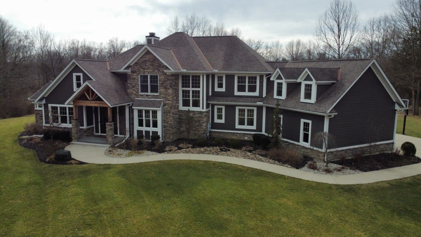 large dark grey home with white trim, many windows, and a path to walk on outside in Jeffersonville OH