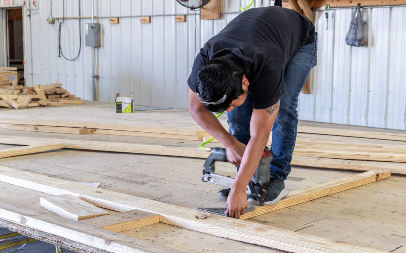 man assembling roo trusses for 40x80 barndominium kits