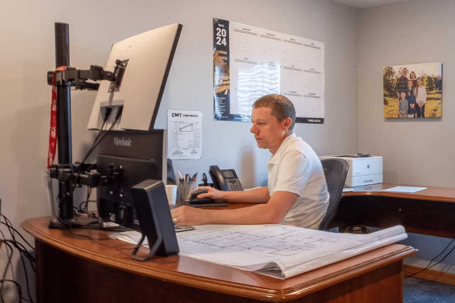 man designing a barndominium kit and providing a quote for the project
