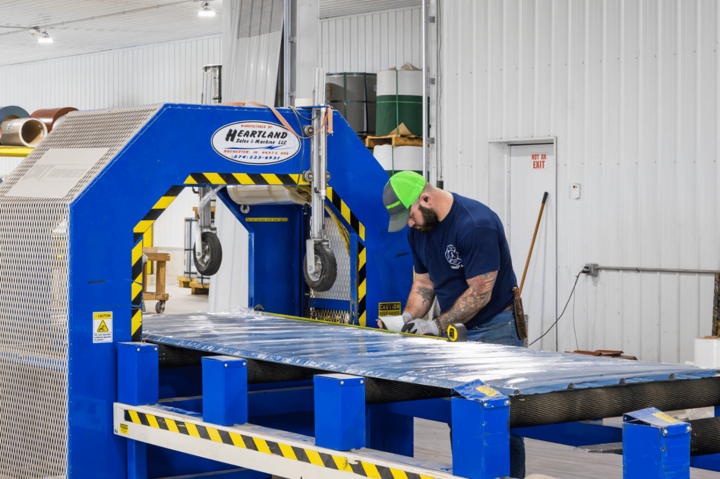 metal panels being manufactured for 80x90 garage pole barn kits