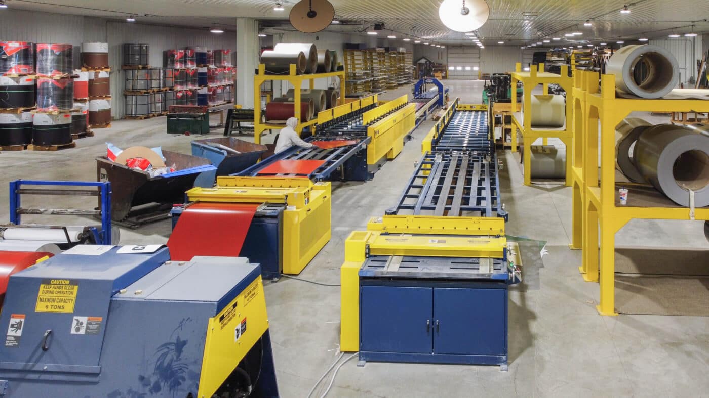 A man working on manufacturing metal sheets for 25x25 barndominiums