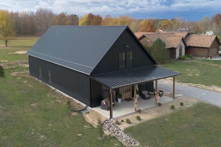 medium all black barndominium with overhang