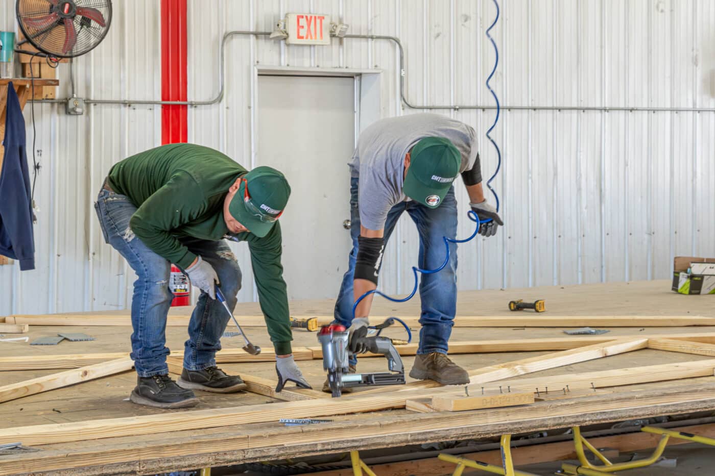 men working on manufacturing roof trusses