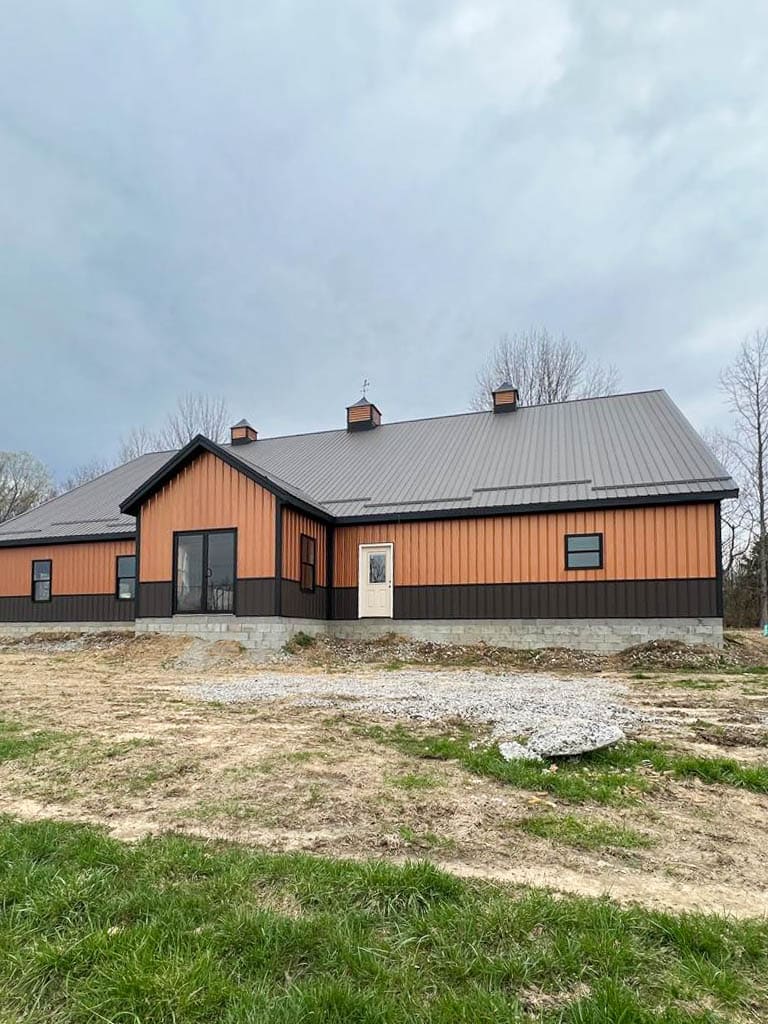 orange and brown trimmed 75x100 commercial pole barn