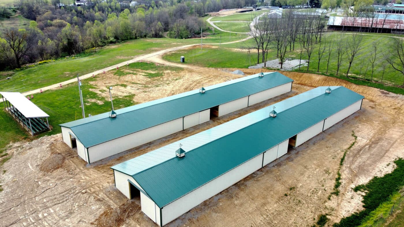 overhead view of green and tan metal 60x60 equestrian pole barns