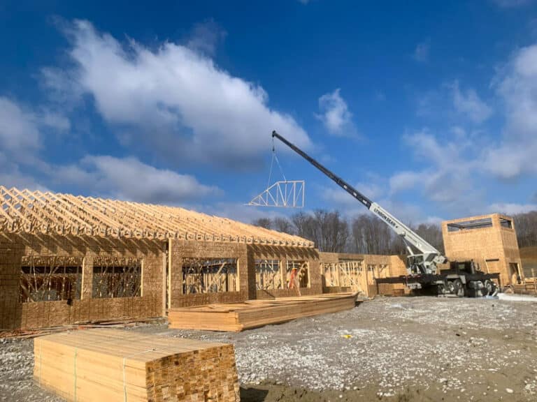 pole barn project in richmond ky featuring crane lowering roof trusses