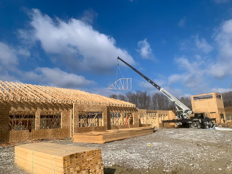 pole barn project in richmond ky featuring crane lowering roof trusses