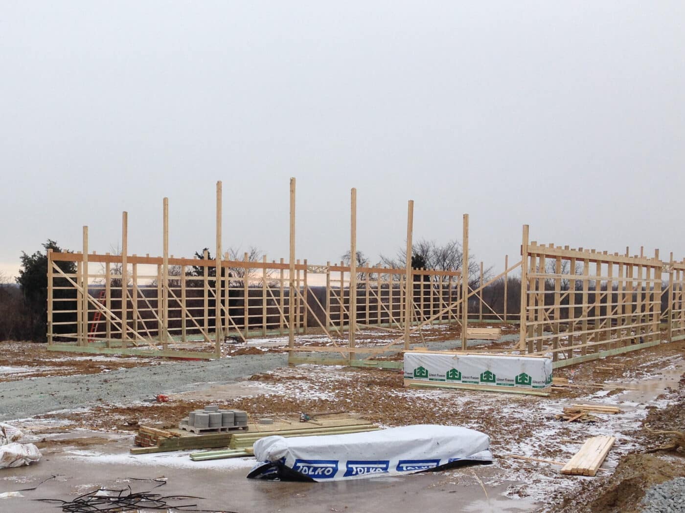 posts of pole barn being set