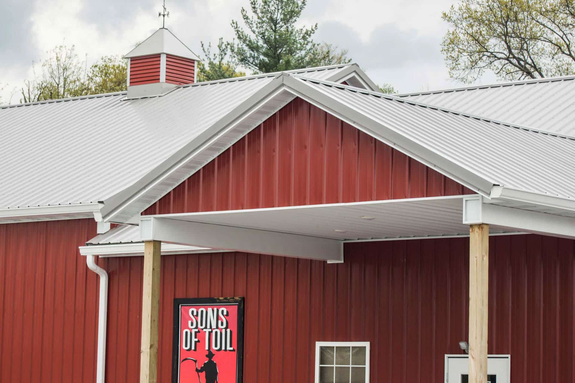 red 56x80 commercial pole barn with gray roof