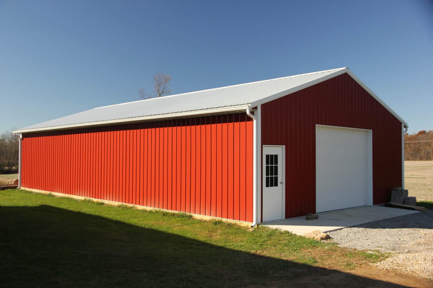 red 24x32 agricultural pole barn with white doors
