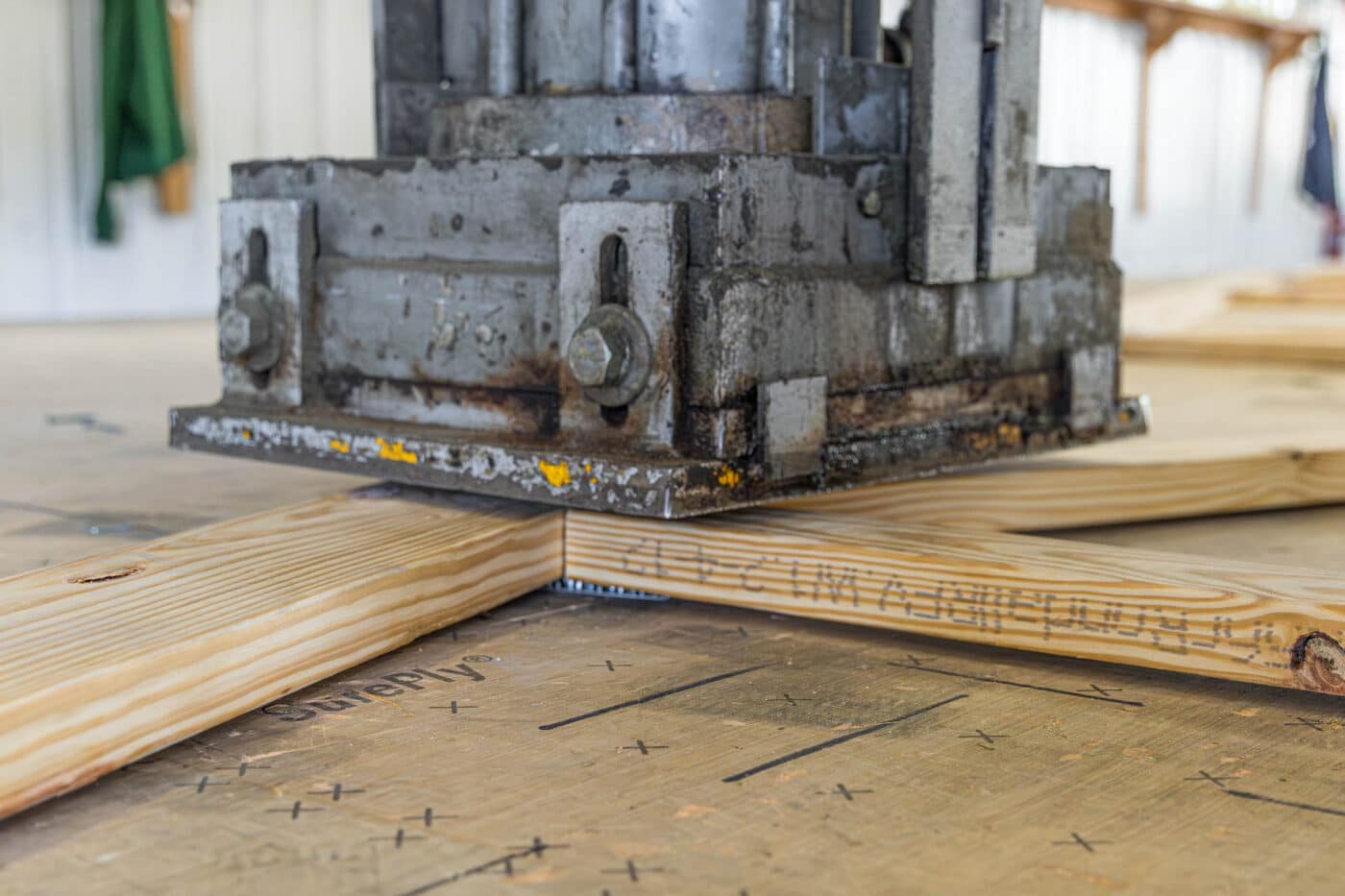 roof trusses being manufactured with large metal machine