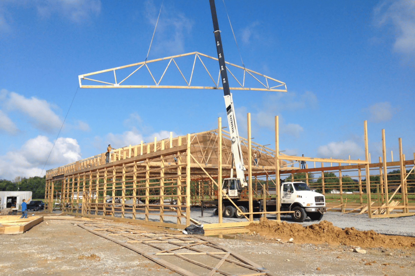 roof trusses being constructed with a crane for pole barn kit in miamisburg ohio