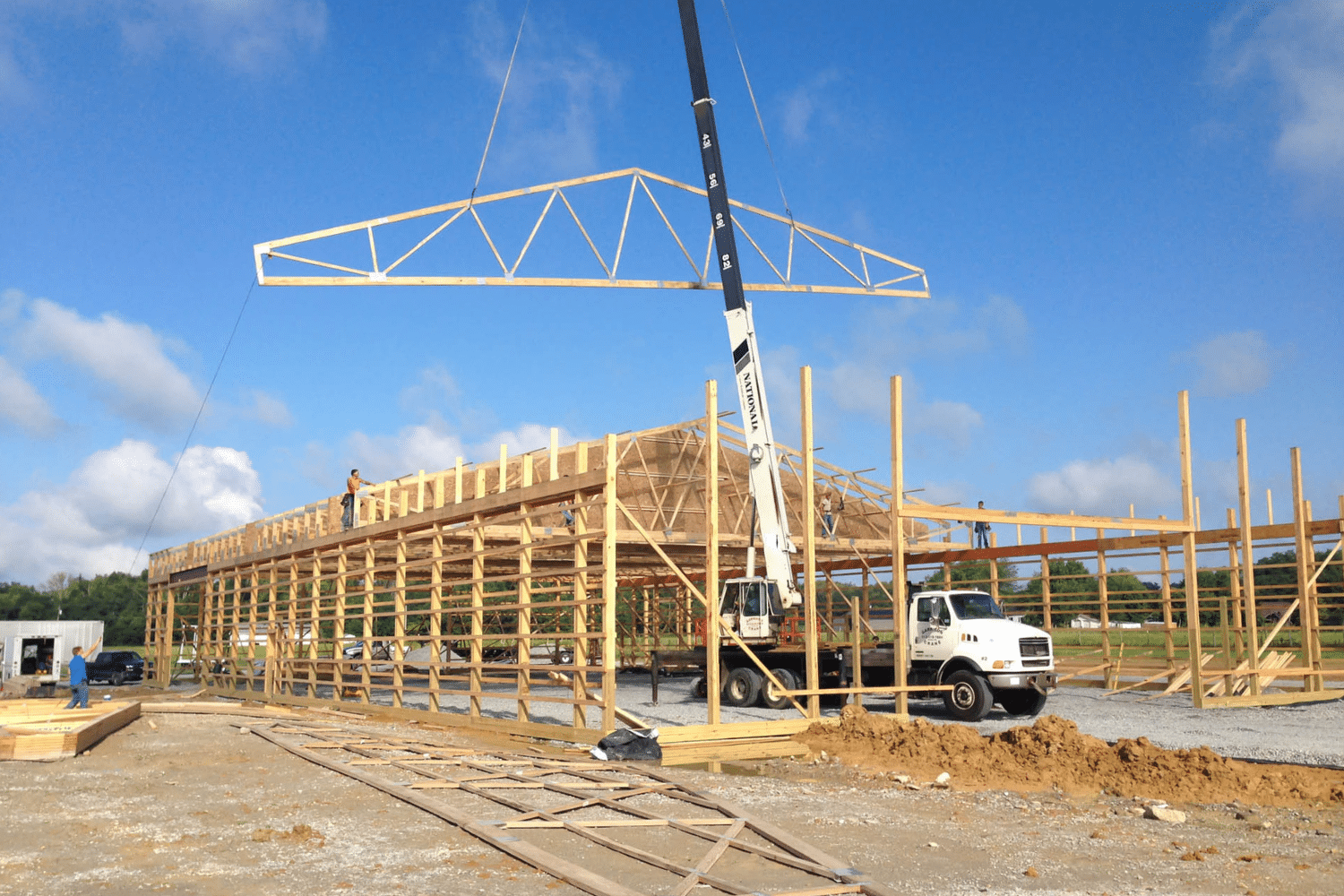 roof trusses being constructed with a crane for pole barn kit in miamisburg ohio