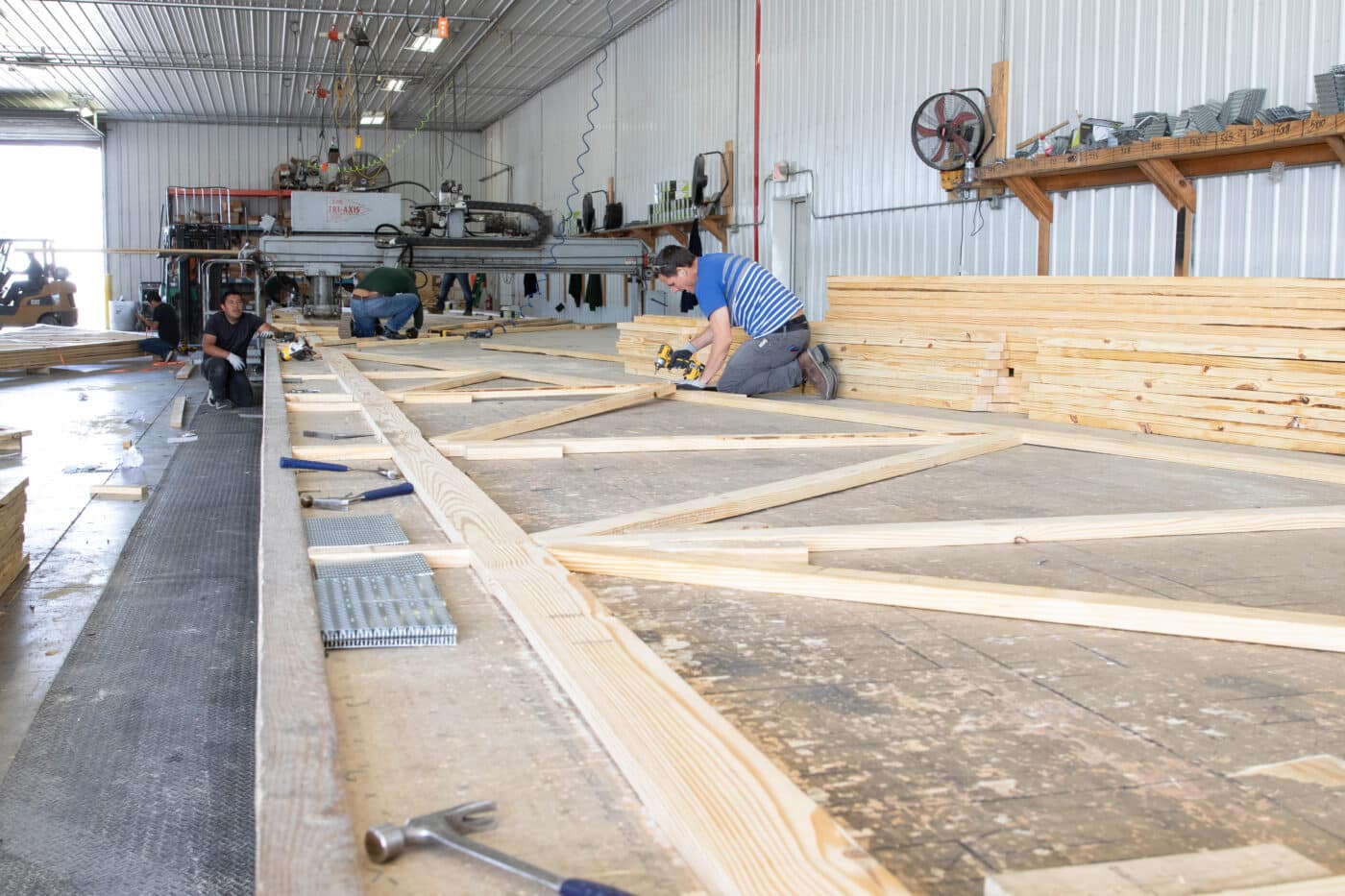 wooden roof truss being assembled in an in-house facility