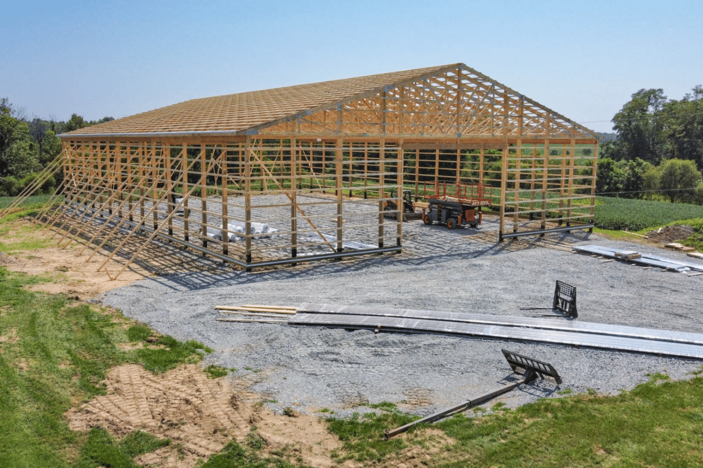 roof trusses on construction site for 80x120 garage pole barn kit