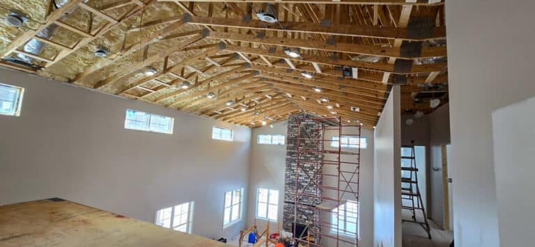 roof trusses inside home with white walls and stone fireplace roof trusses in cattlesburg ky