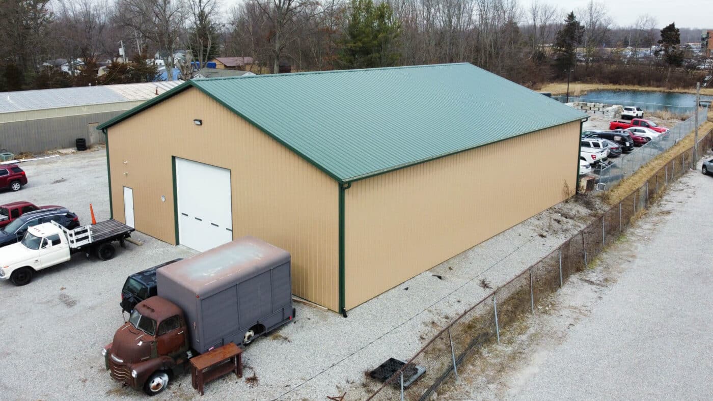 tan 56x80 commercial pole barn with green metal roof