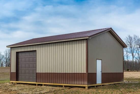 tan and brown pole barn with dark brown metal roof and one brown overhead door